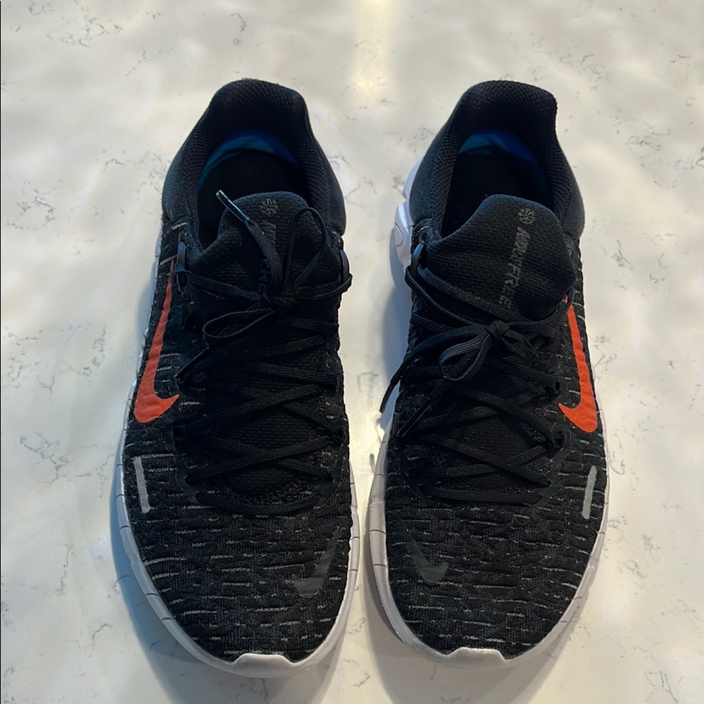 Black nike Athletic Shoes with orange, blue and purple back